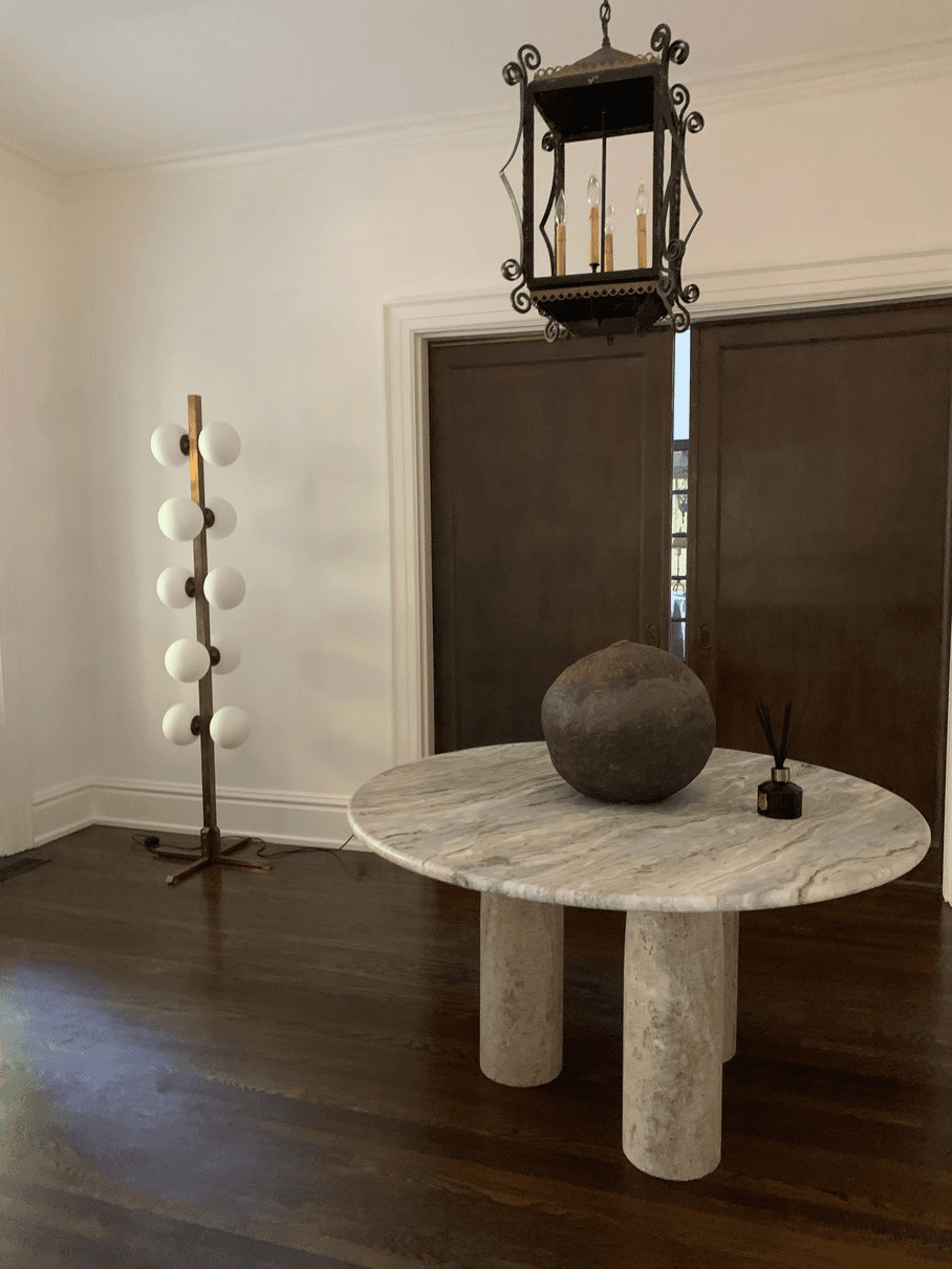 Curated entry — marble table, vintage lantern, modern floor lamp
